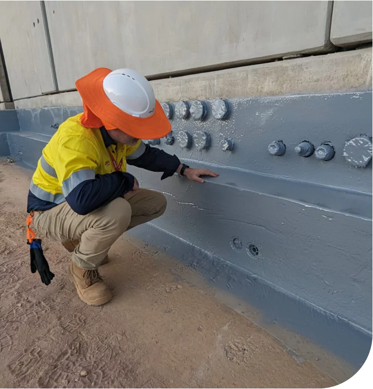 Inspector Assessing Coated Steel Structure