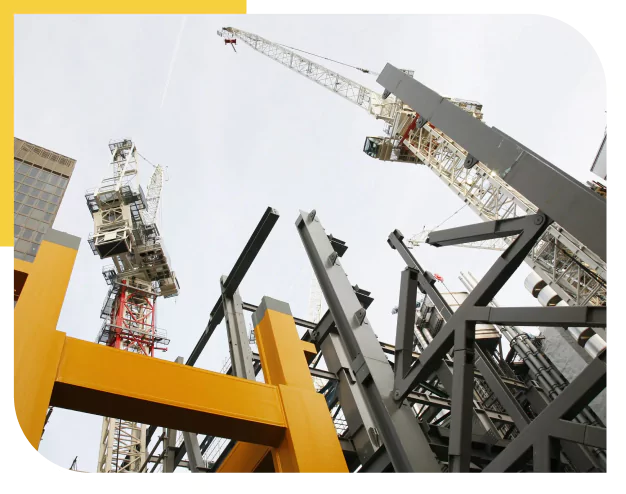 Construction site with cranes and structural steel framework