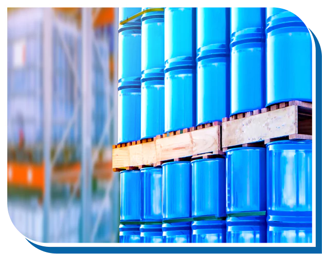 Blue chemical storage barrels in a warehouse