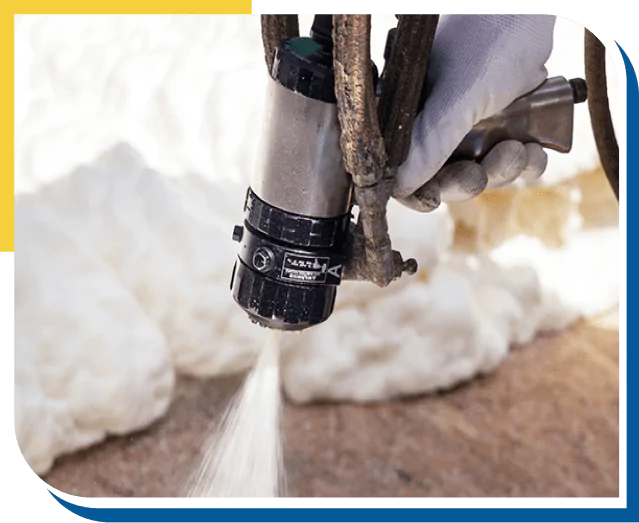 Worker applying spray foam insulation